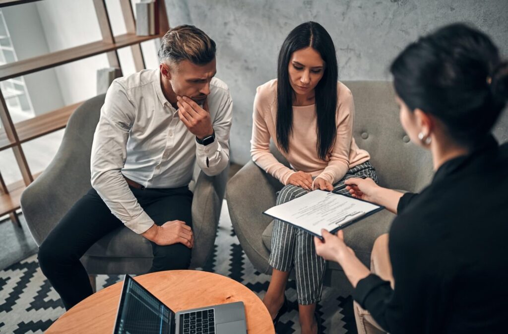 Couple signs divorce agreement with family law attorney as witness in Dayton, Ohio