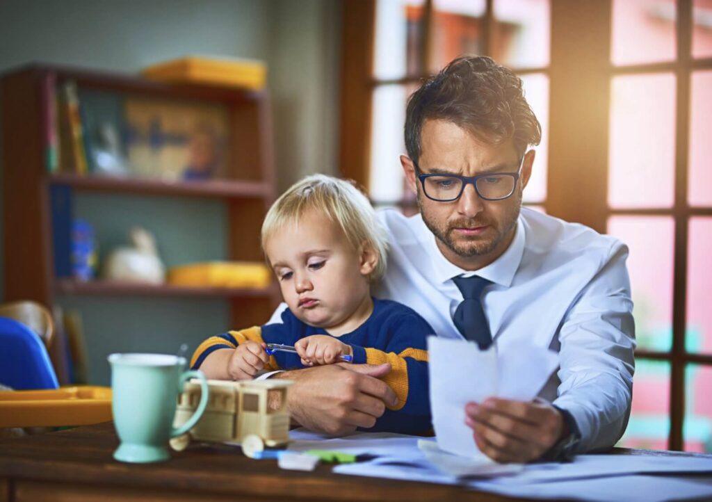 A divorced father goes over bills in Dayton, Ohio