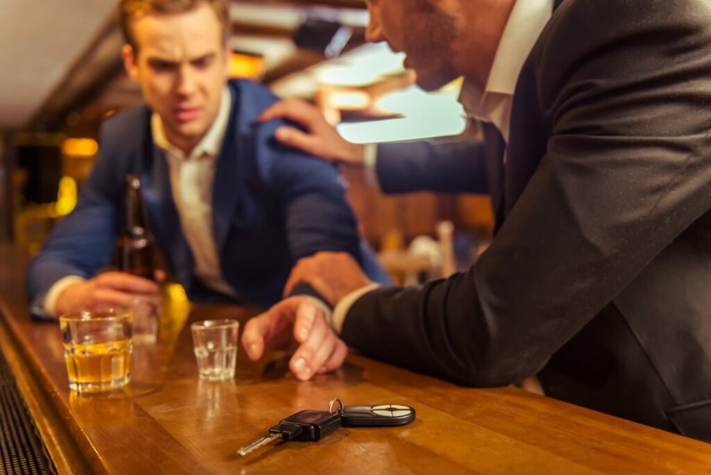 an intoxicated man reaches for his car keys